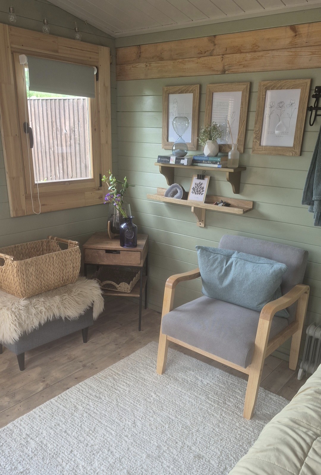 The calm treatment room with sage green walls and comfortable seating